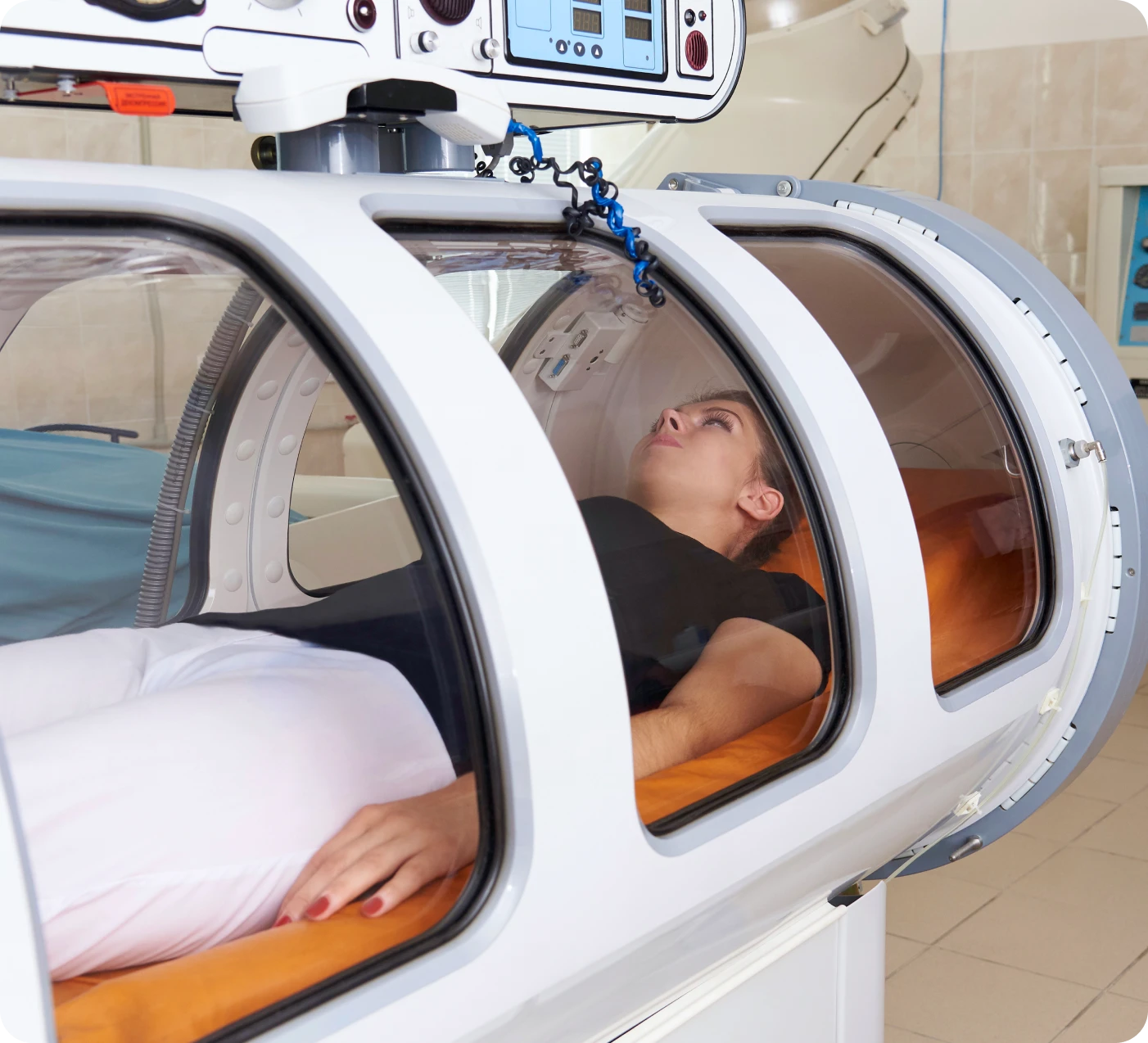 Person inside a hyperbaric oxygen therapy chamber.