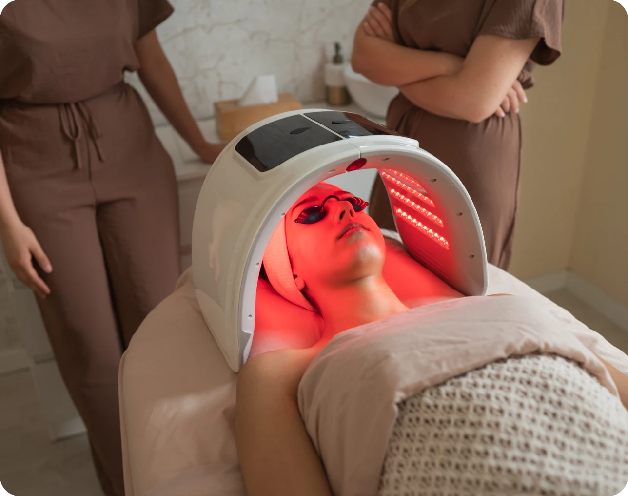 Person receiving LED light therapy treatment.