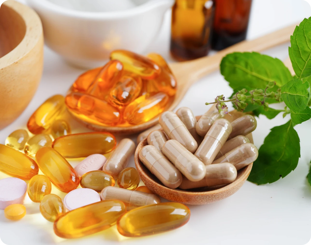 Supplements and herbs on a wooden spoon.